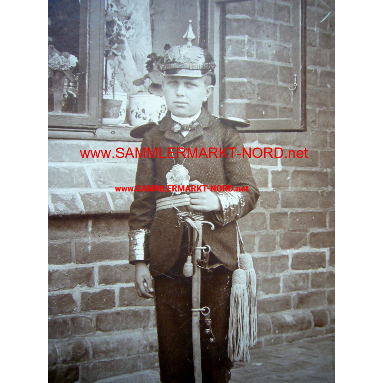 Cabinet photo - child in uniform with spiked helmet