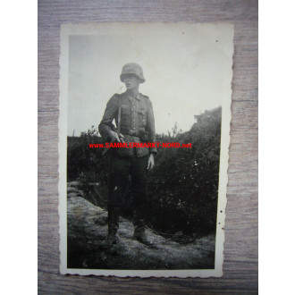 Infantryman with MP and steel helmet with camouflage cover
