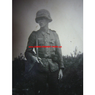 Infantryman with MP and steel helmet with camouflage cover