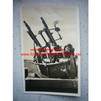 Twin machine gun in fire position - postcard